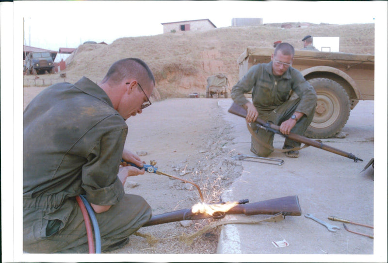 The Rwandan War:French soldiers destroy arms confiscated. - Vintage Photograph