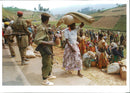 Rwanda war:a rwandan woman walks past rwandan patriotic front soldier. - Vintage Photograph