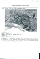 Rwanda war:army troops distributes water to refugees at the mp. - Vintage Photograph