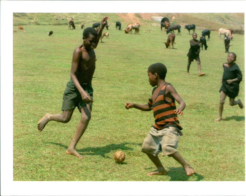 rwanda war.young rwandan animal herders play soccer - Vintage Photograph