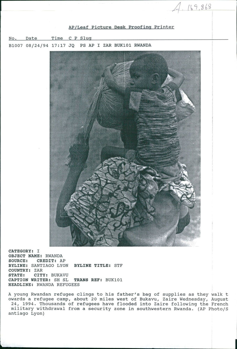 A young Rwandan refugee clings. - Vintage Photograph