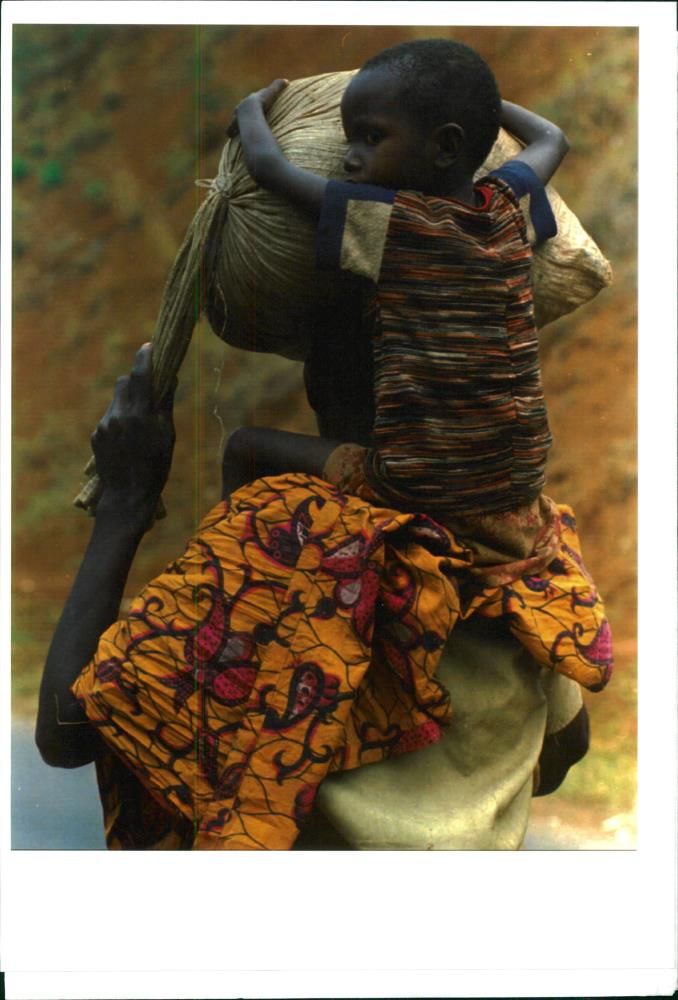 A young Rwandan refugee clings. - Vintage Photograph