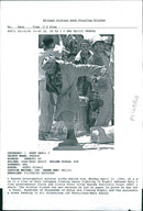 A Rwanda Governmental soldier kicks behind him. - Vintage Photograph