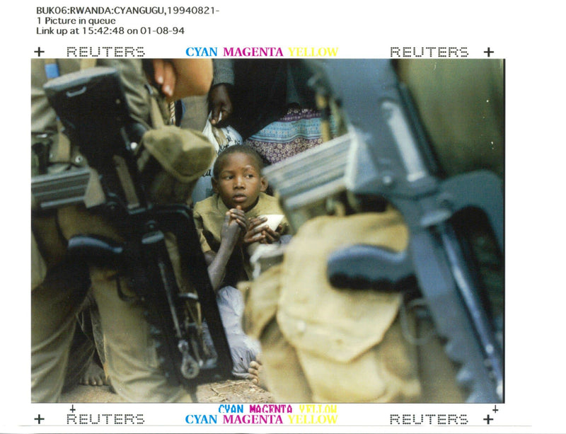 A little Hutu girl sits tensely within a crowd of some 10,000 Rwandan refugees. - Vintage Photograph