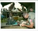 Rwanda war:a french soldier treats a boy. - Vintage Photograph