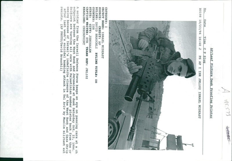 A Israeli soldier keeps an eye on passing cars at a checkpoint - Vintage Photograph