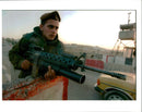 A Israeli soldier keeps an eye on passing cars at a checkpoint - Vintage Photograph