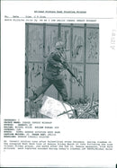 Israel hebron mosque massacre:an israel soldier runs after palestinians throwers. - Vintage Photograph