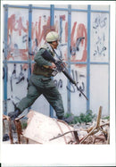 Israel hebron mosque massacre:an israel soldier runs after palestinians throwers. - Vintage Photograph