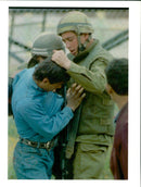 West Bank:An Israeli soldier grabs a Palestinian youth. - Vintage Photograph