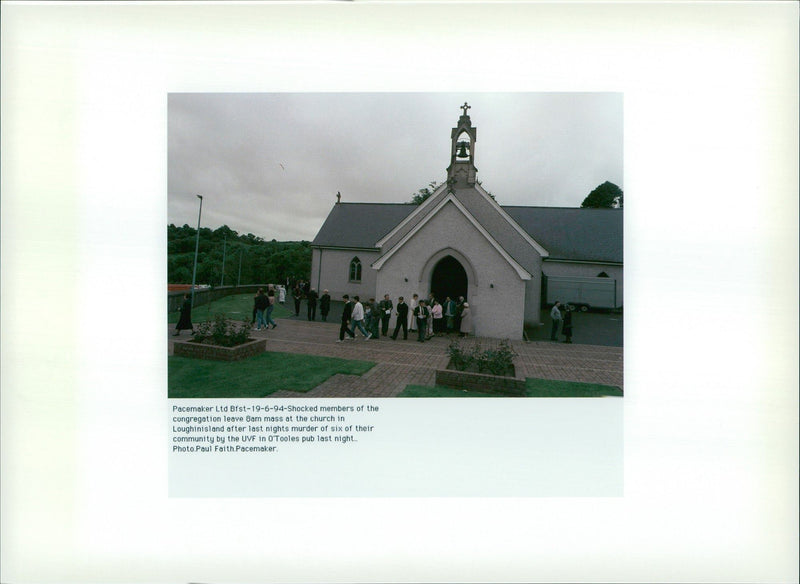 Shocked members of the cogregation leave 8am mass at the church in loughinisland after last nights murder of six of their community by the UVF in O tooles pub last night. - Vintage Photograph