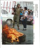 West Bank (Hebron):An Israeli soldier collars a Palestinian teenager. - Vintage Photograph