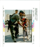 West Bank (Hebron):An Israel army officer pushes a young Jewish settler. - Vintage Photograph