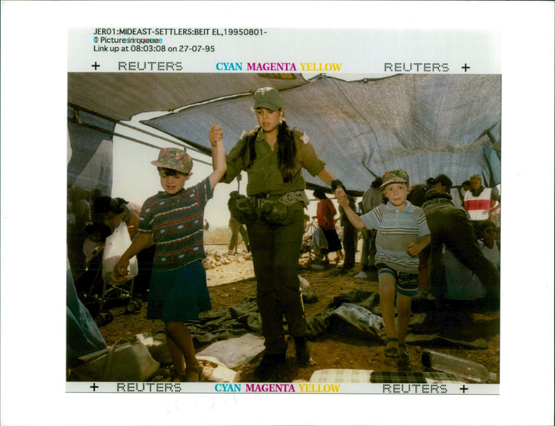 Beit El: A woman Israeli soldier holds the hands of a small Israeli girl. - Vintage Photograph