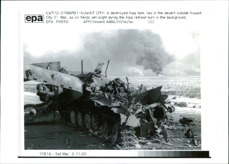 A destroyed iraqi tank lies in the desert outside kuwait city. - Vintage Photograph