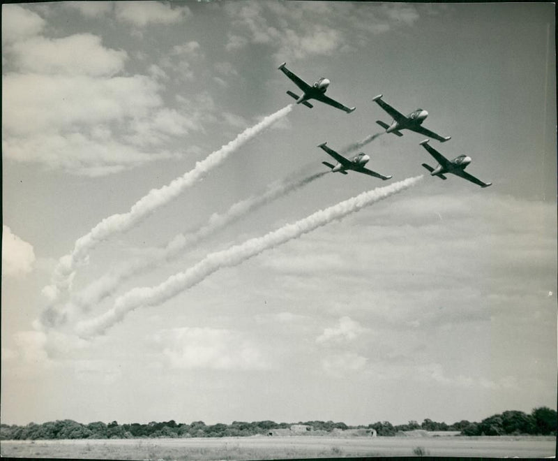 Jet provost training leave smoke plumes across the sky. - Vintage Photograph