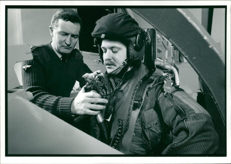 An unidentified pilot with an assistant. - Vintage Photograph