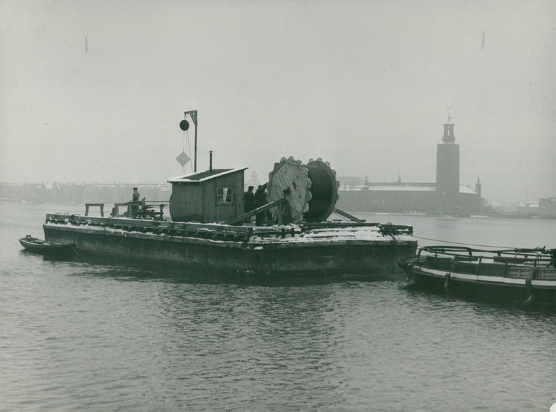 Plastic pipes are laid down on the bottom of RiddarfjÃ¤rden to prevent it from freezing again - Vintage Photograph