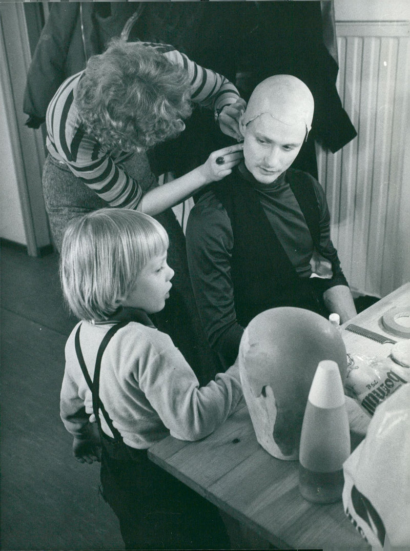 Dalateatern plays at Wasa Bio in RÃ¤ttvik. Christer Frodin gets help with the mask by Barbro Enberg, and actress Ola Eldh 4 years. - Vintage Photograph
