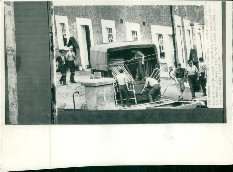 Irish Army Troops unload beds to set up a field hospital. - Vintage Photograph