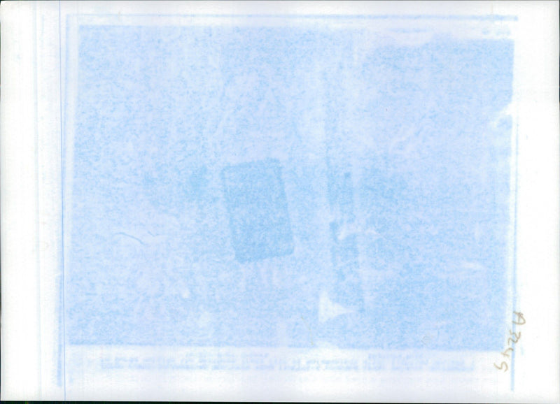 1991 uprisings in Iraq: A man throwing a stone to two person with bloody faces. - Vintage Photograph