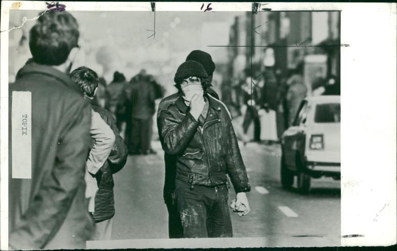 Civil rights riots 1976-1979:a masked youth armed with stones walking in the newtownards. - Vintage Photograph