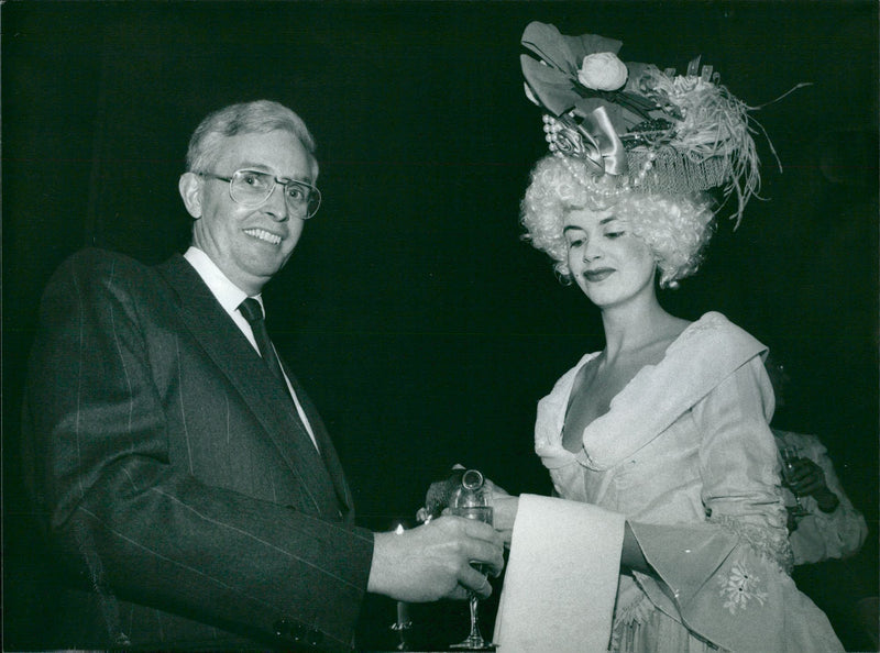 Concert Hall Manager Ãke Holmquist is served by Tina Nyman during Svenska Dagbladet's New Year's Concert at the Stockholm Concert Hall - Vintage Photograph