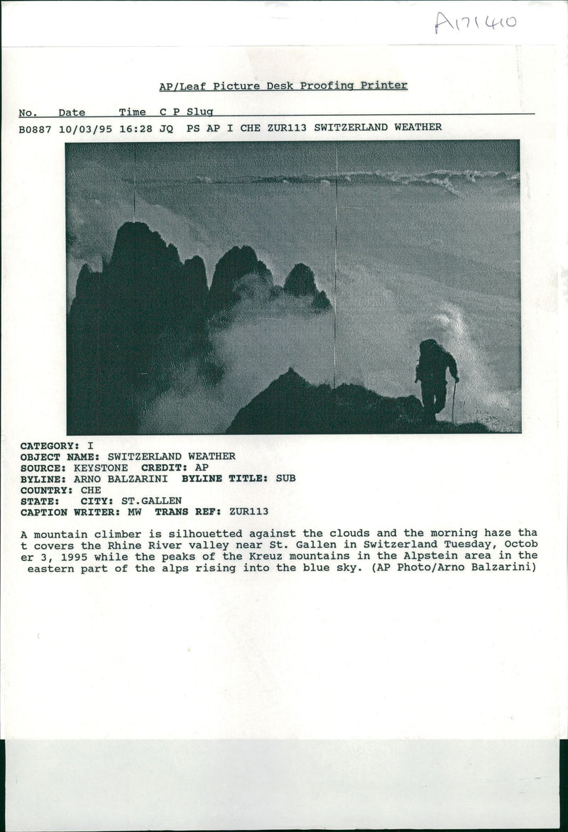 A mountain climber is silhouetted against the clouds. - Vintage Photograph
