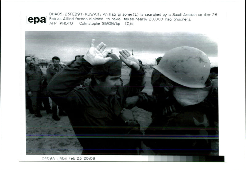 Iraq war pow:a iraq prissoner is search by a saudi arabian. - Vintage Photograph
