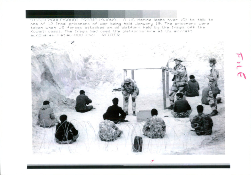 Iraq war pow:u.s marine leans over. - Vintage Photograph