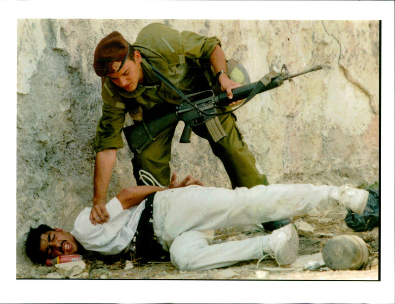 Jerusalem, Jewish Settlers: An ISraeli soldier and a Palestinian man. - Vintage Photograph