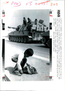 An Iraqi boy gathers food. - Vintage Photograph