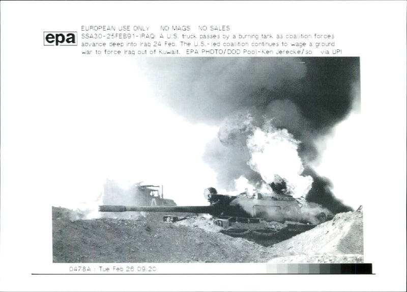 Iraq -un war kuwait city war damage:iraq A.U.S truck passed by a burning tank. - Vintage Photograph