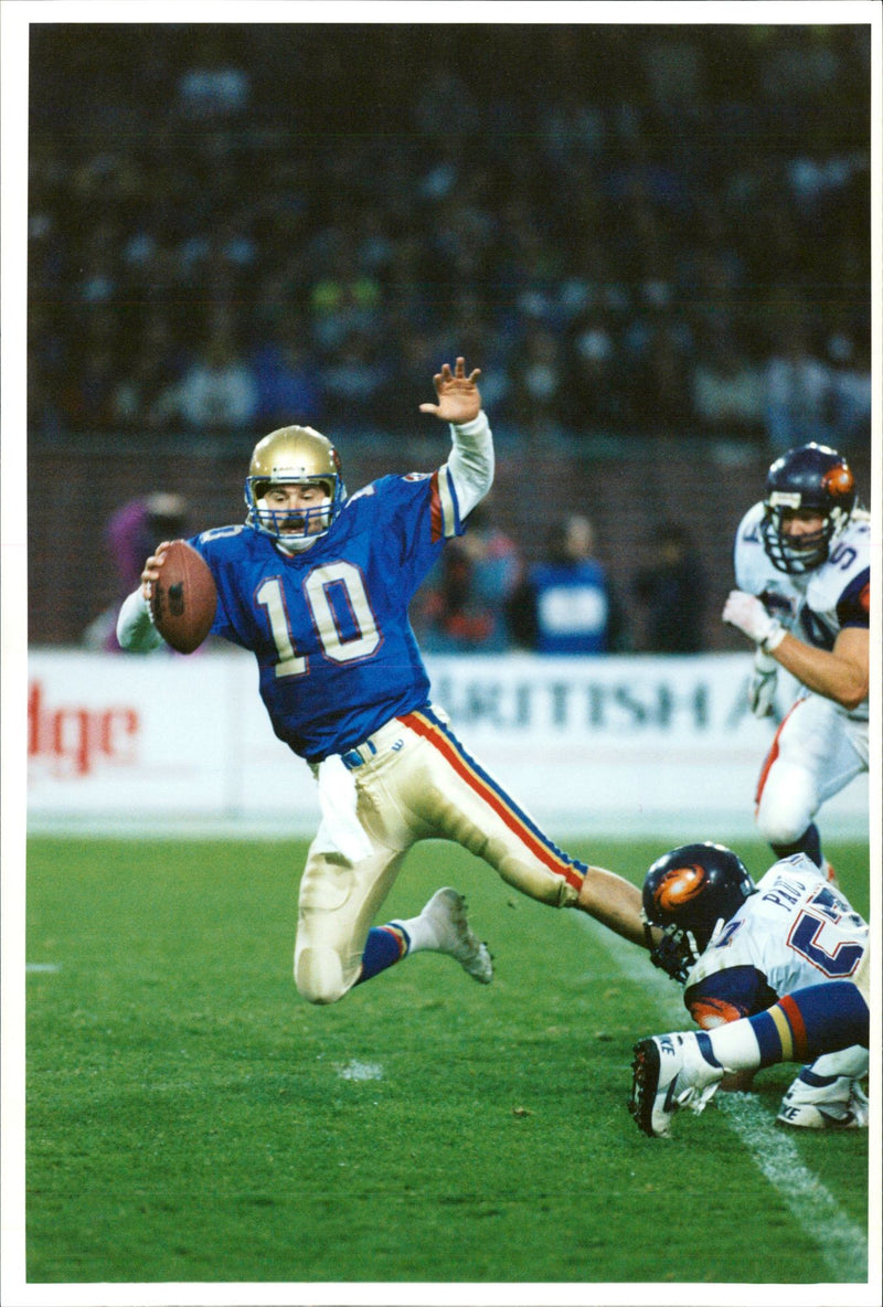 American football british teams:monarch's stan gelbaugh caughtin full flow. - Vintage Photograph