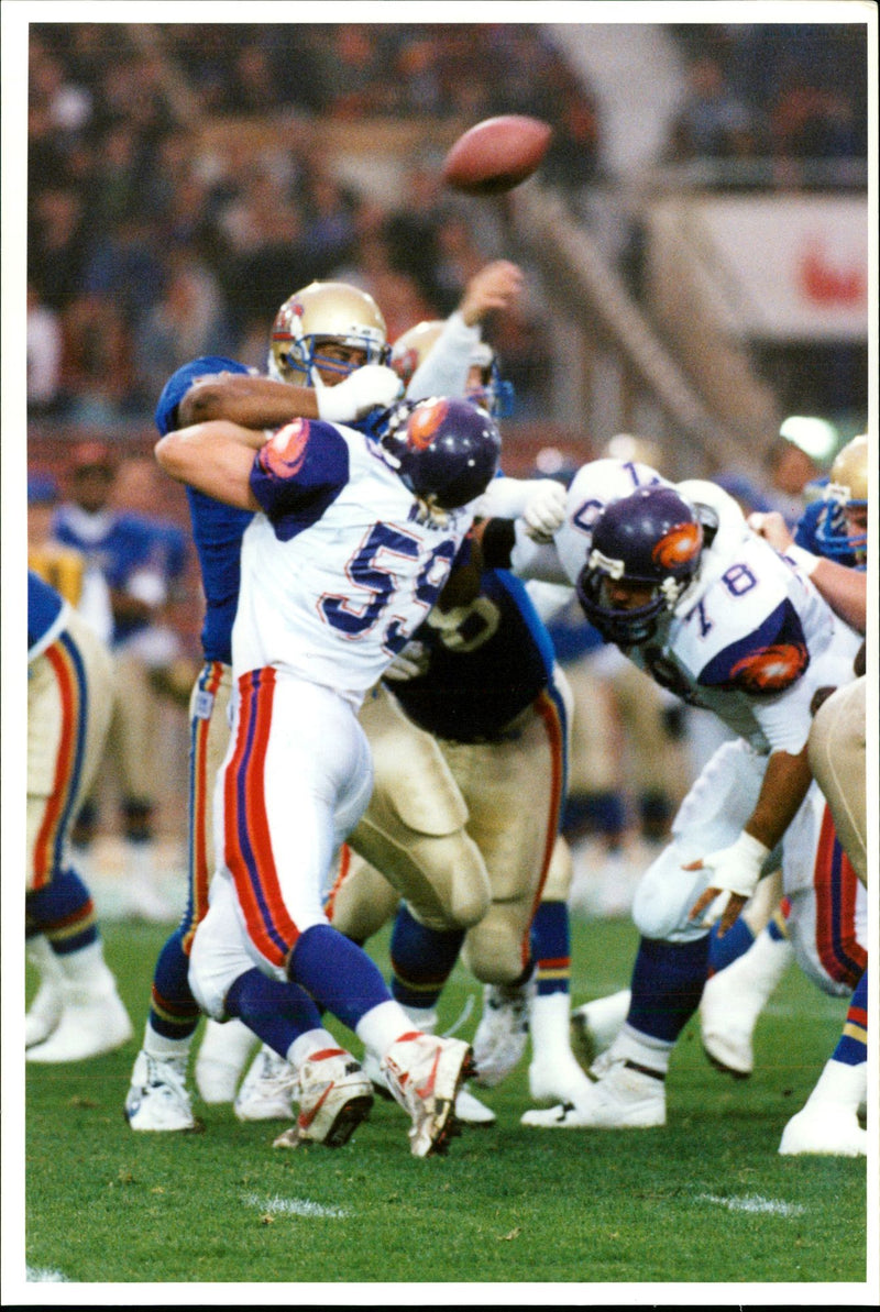 American football british teams:the ball goes loose at wembley stadium. - Vintage Photograph