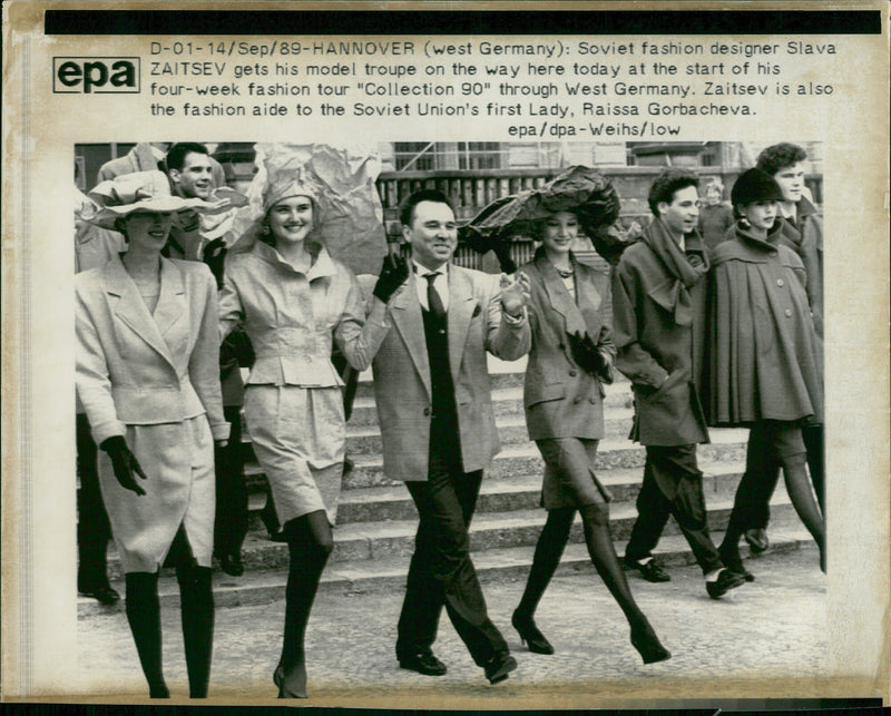 Soviet fashion designer Slava Zaitsev directs his model troupe at the start of a fashion tour in West Germany. - Vintage Photograph