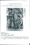 A Kuwaiti offcial watches British soldiers. - Vintage Photograph