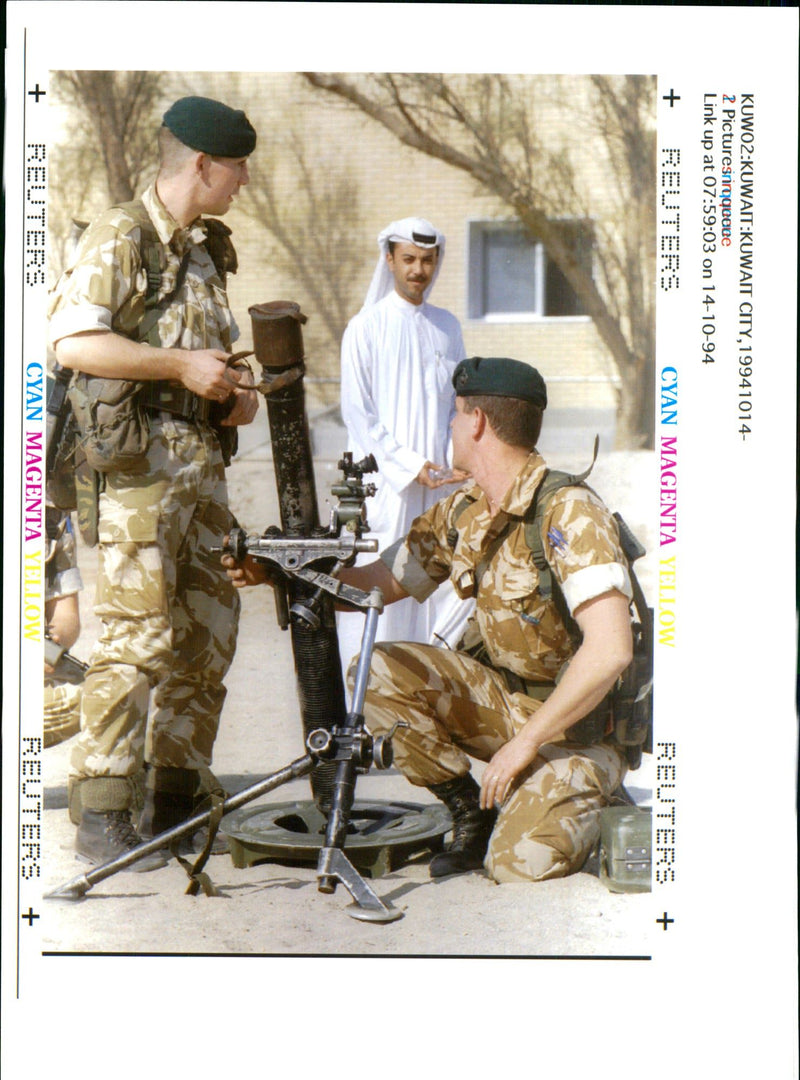 A Kuwaiti offcial watches British soldiers. - Vintage Photograph
