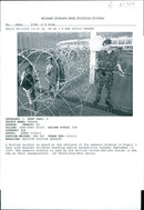 A British soldier on guard with Rwandan Children. - Vintage Photograph