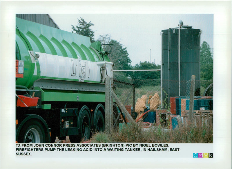 Firefighters pump the leaking acid into a waiting tanker - Vintage Photograph