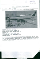 United airlines employees gather around a Boeing 777. - Vintage Photograph