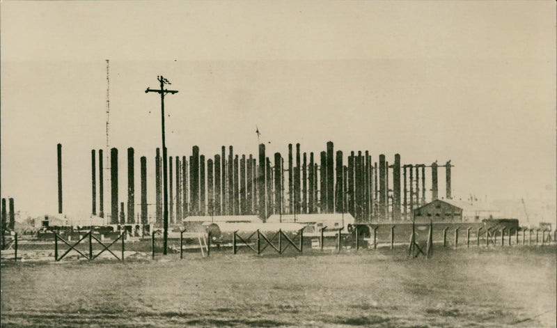 Auburn golf course: slim metal tanks point skyward. - Vintage Photograph