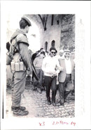 An Israeli soldier stands guard to prevent trouble. - Vintage Photograph