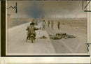 Jubilant iranian soldiers riding past dead iraqi troops. - Vintage Photograph