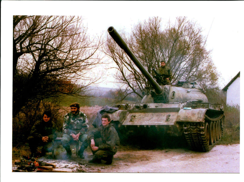 A bosnian serb tank crew warm themselves. - Vintage Photograph