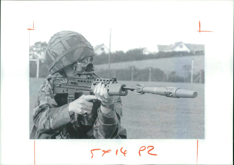 A soldier prepares to fire a Heat grenade. - Vintage Photograph