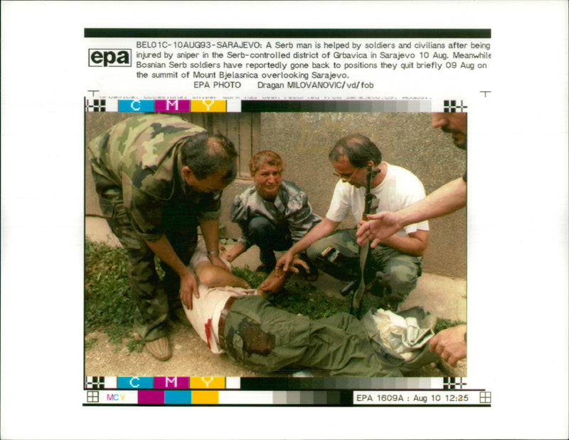 A serb man is helped by soldiers and civilians. - Vintage Photograph