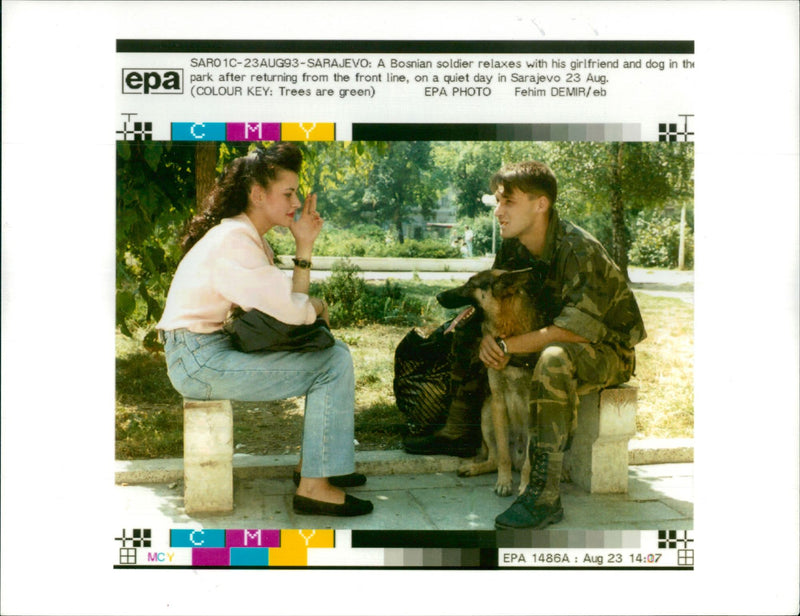 A Bosnian soldier relaxes with his girlfriend. - Vintage Photograph