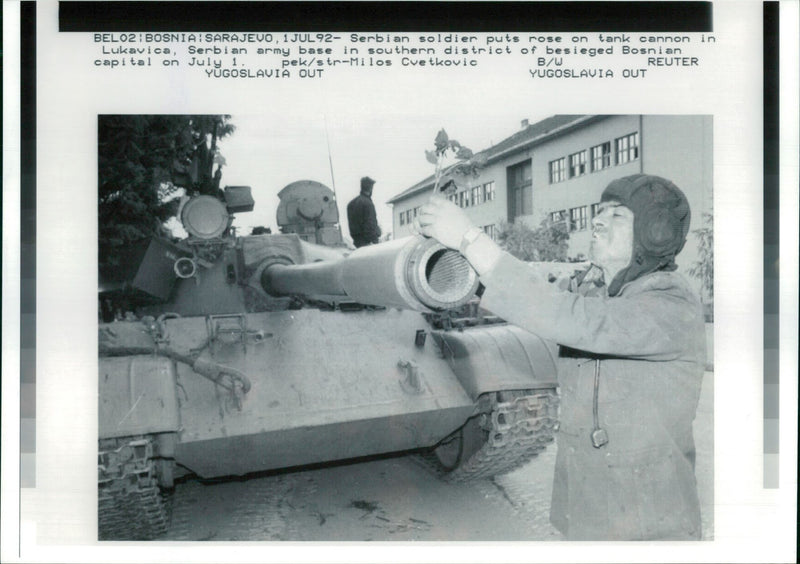 Serbian Soldier puts a rose in tank cannon. - Vintage Photograph