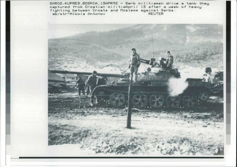 The Serb militiamen drive a tank they captured. - Vintage Photograph